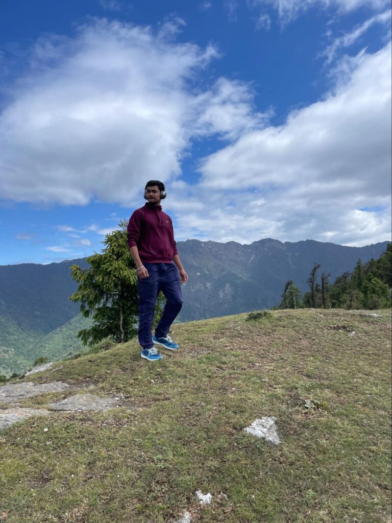 Scenic view of Churdhar peak surrounded by lush greenery and clear skies